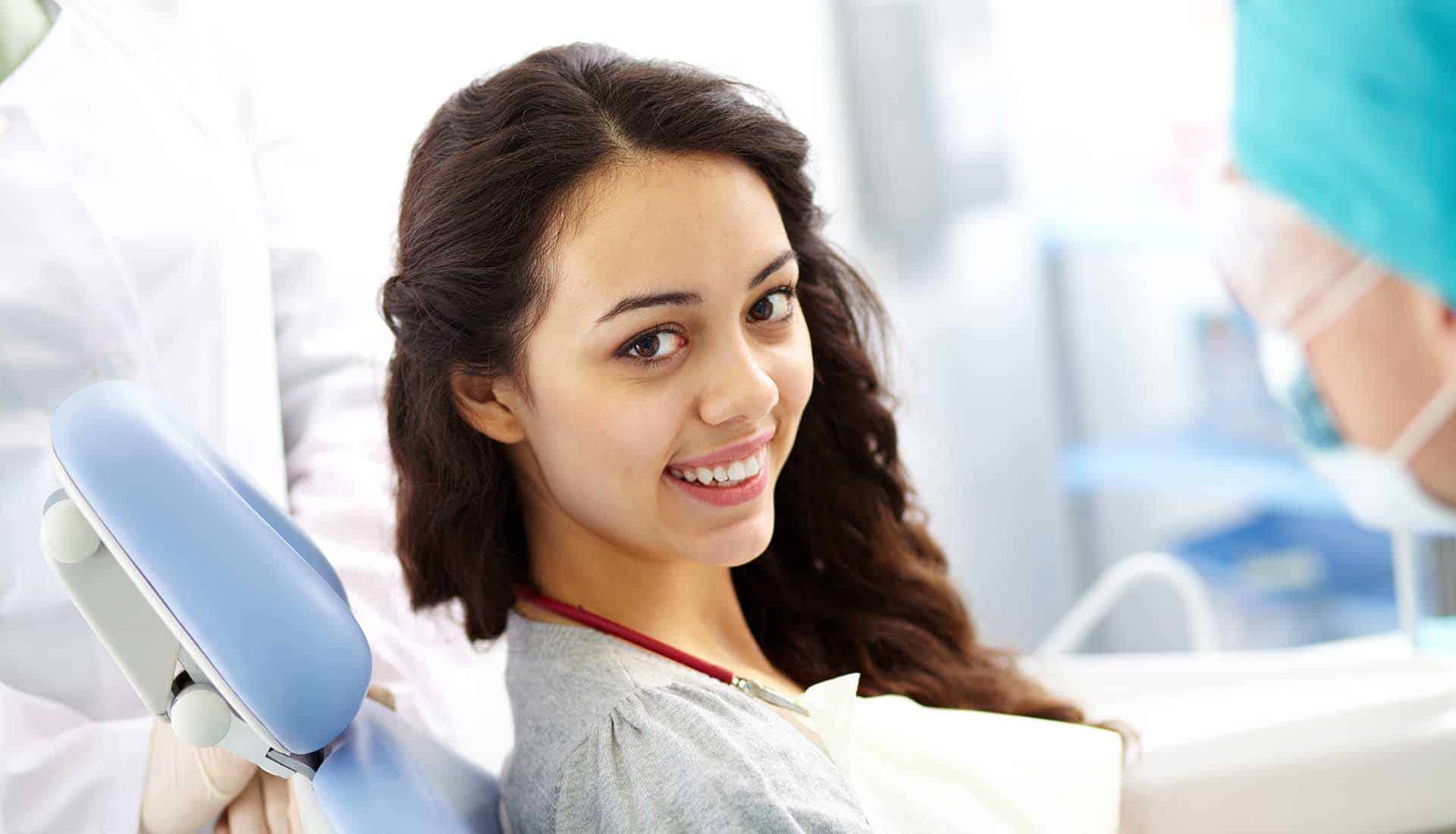 Young woman sitting in a dental chair.