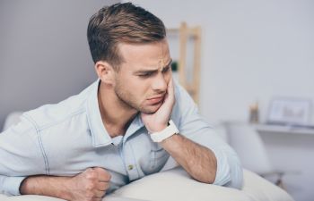 Man suffering from dental pain.